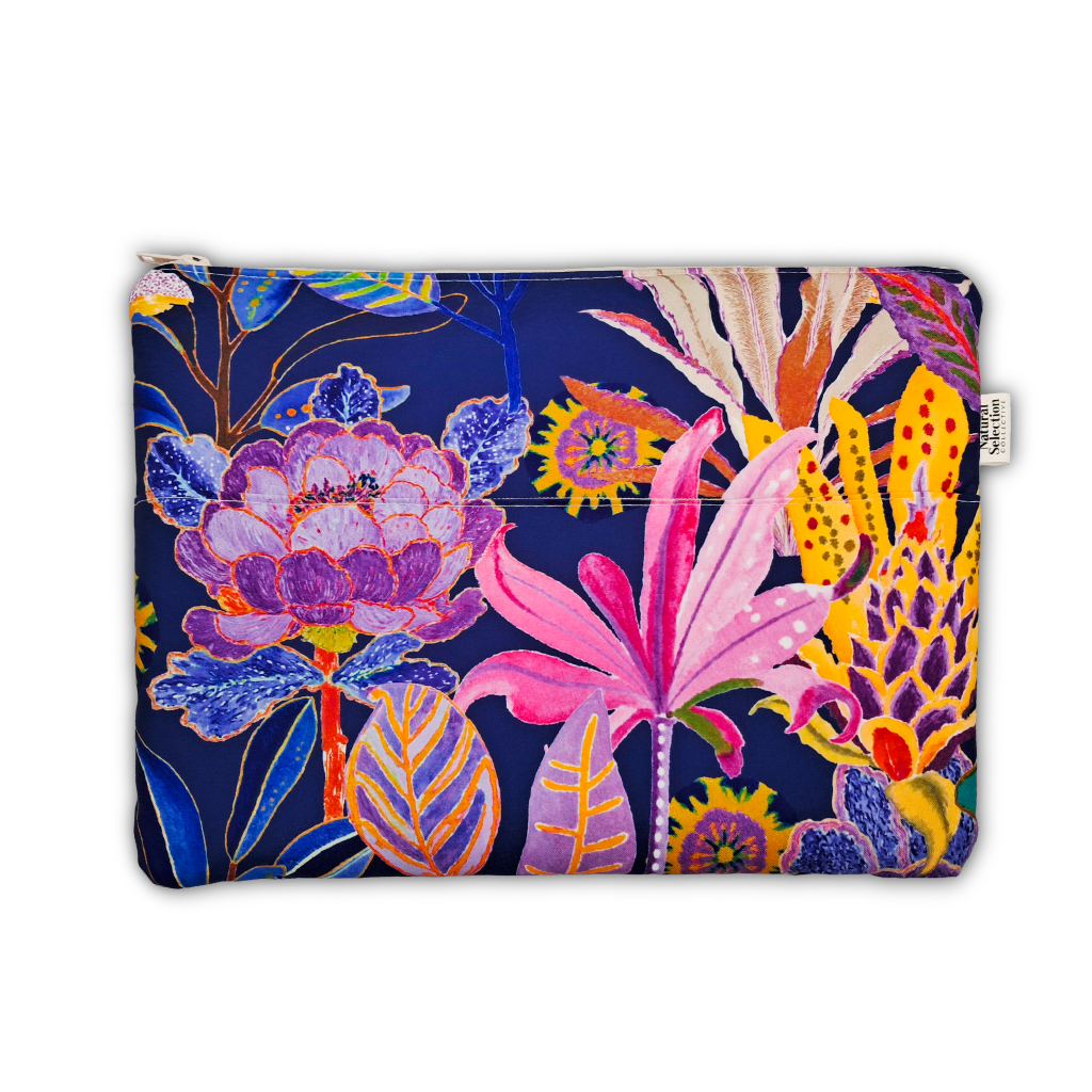 A zippered pouch featuring a vibrant, multicolored botanical print on a dark navy blue background. The print includes large pink flowers, purple blossoms, yellow sunflowers, and blue leaves.