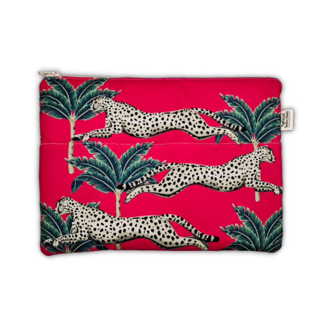 A zippered pouch featuring a vibrant pink background with a pattern of leaping spotted cats and green palm leaves, shown against a plain white background.