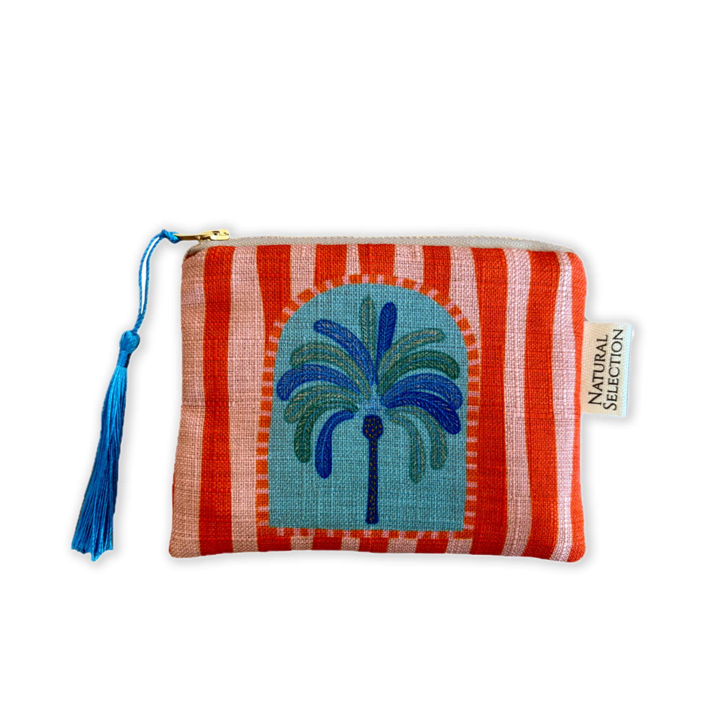 A small zippered pouch with a woven fabric body, featuring a red and white striped pattern, a central blue and green palm tree motif, a blue tassel zipper pull, and a visible Natural Selection brand tag.