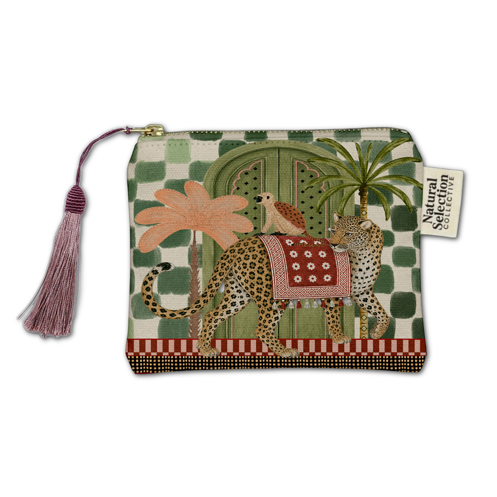 A zippered pouch featuring a whimsical safari-themed illustration with a leopard, palm trees, a bird, and a green patterned background. The pouch has a pink tassel zipper pull and a 'Natural Selection' brand tag.