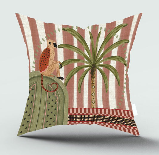 A square decorative throw pillow featuring a stylized illustration of a bird perched on a green pedestal next to a palm tree, set against a background of vertical pink and cream stripes.