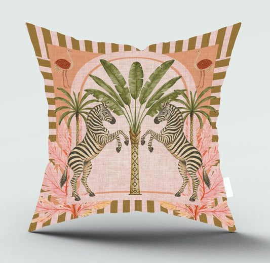 A square decorative throw pillow featuring a retro-style illustration of two zebras facing each other in front of palm trees, with pink tropical leaves and a striped border on a light gray background.