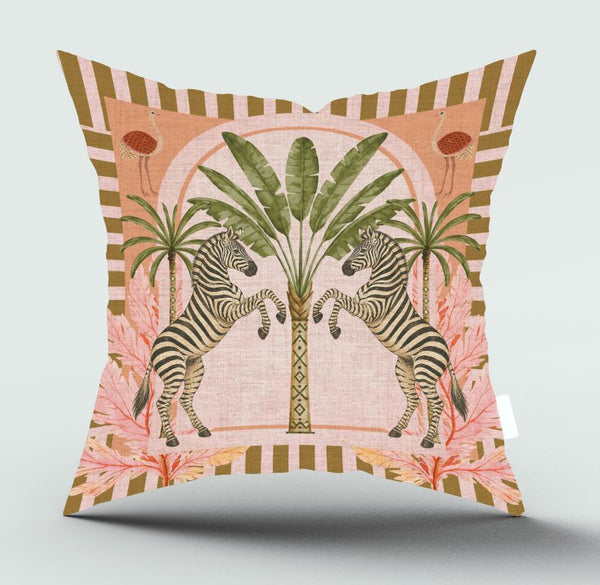 A square decorative throw pillow featuring a retro-style illustration of two zebras facing each other in front of palm trees, with pink tropical leaves and a striped border on a light gray background.