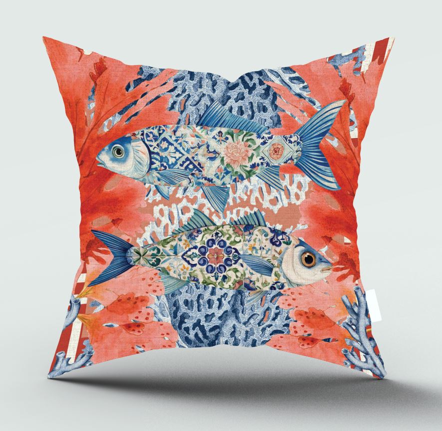 A square decorative throw pillow featuring a vibrant underwater scene print with two ornate blue fish on a coral reef background, shown against a neutral light gray backdrop.