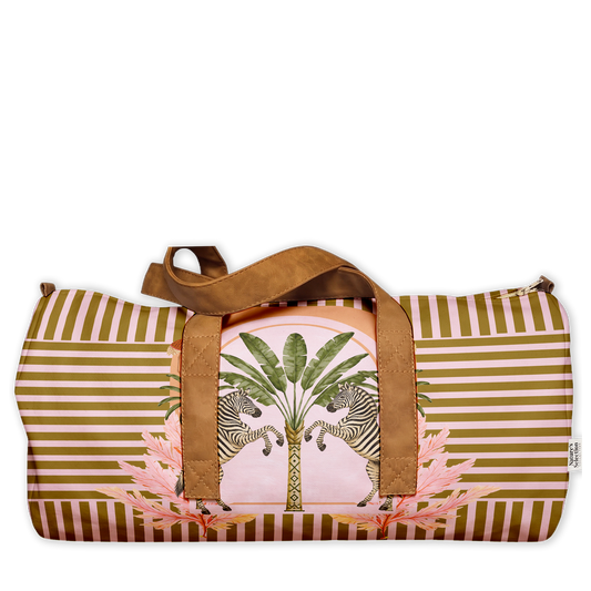 Babylon Zebras Duffel Bag featuring two zebras beside a palm tree on pink with an olive stripe border