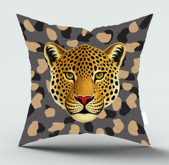 A square throw pillow featuring a detailed graphic of a leopard's face in the center, set against a dark gray background with beige and black leopard spots.
