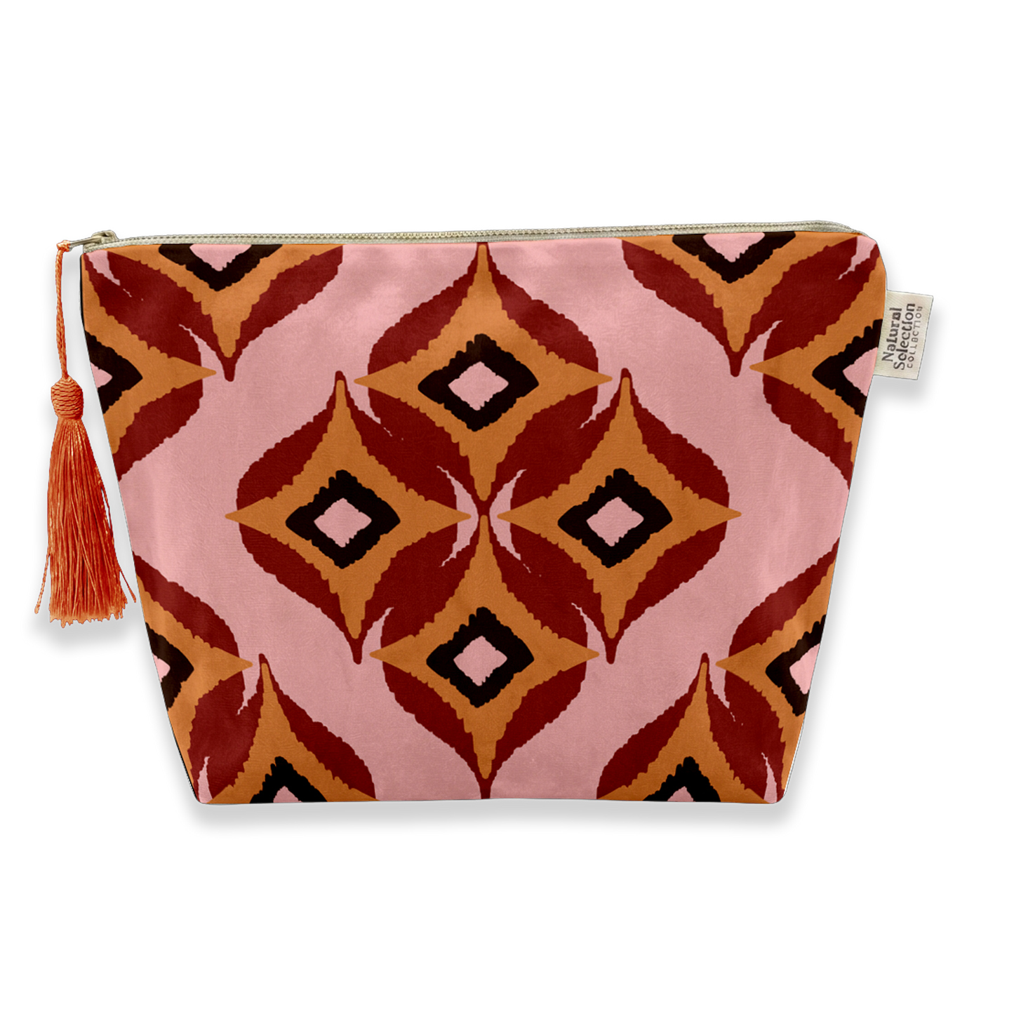 A zippered cosmetic pouch featuring a pink, rust red, orange, and black geometric ikat pattern with a matching tassel zipper pull, shown on a white background.