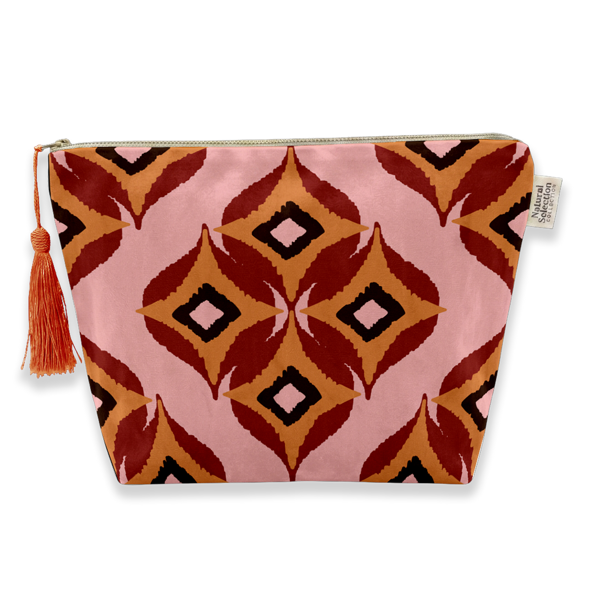A zippered cosmetic pouch featuring a pink, rust red, orange, and black geometric ikat pattern with a matching tassel zipper pull, shown on a white background.
