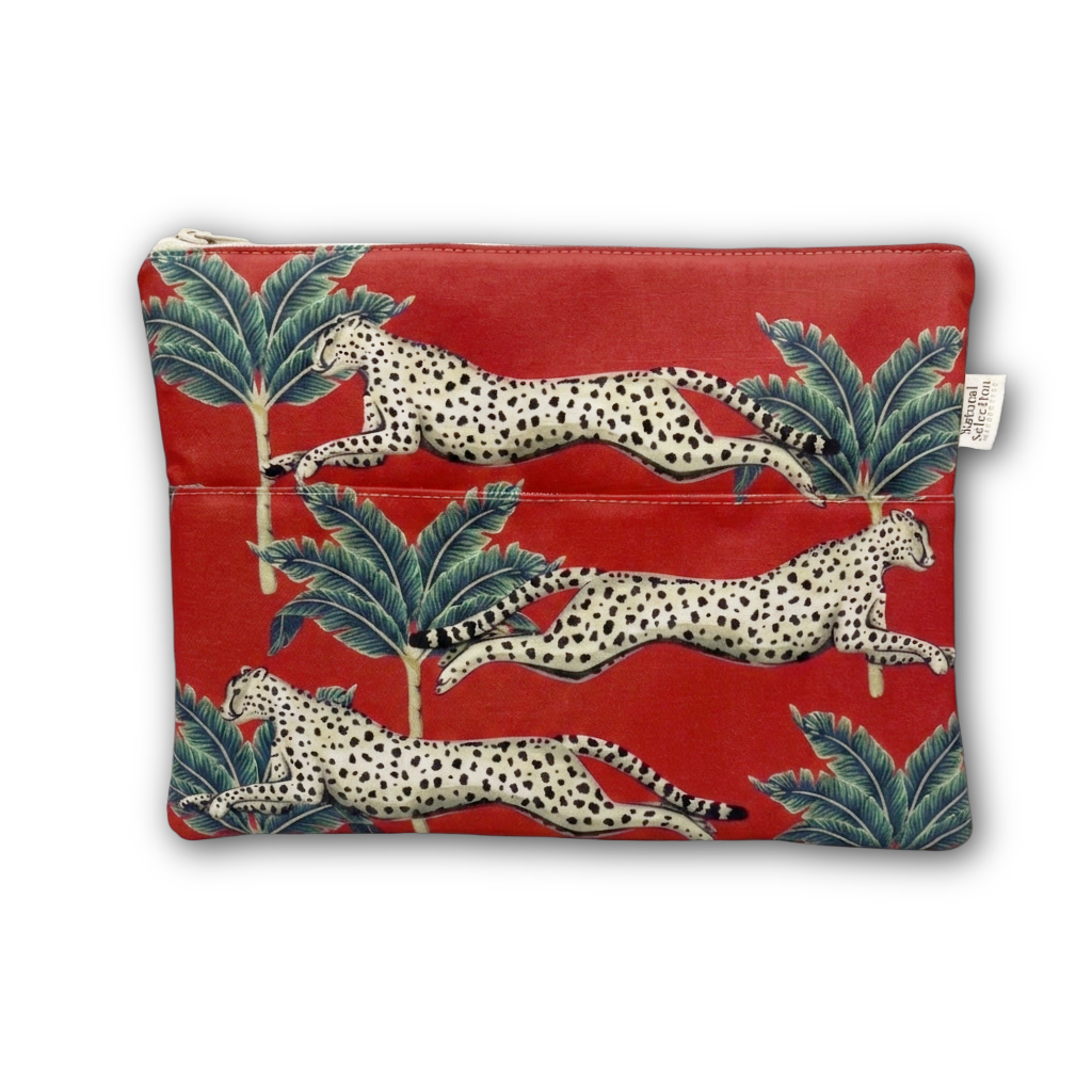 A red zippered pouch featuring a pattern of leaping cheetahs and green palm trees, with a small white brand tag on the right side.