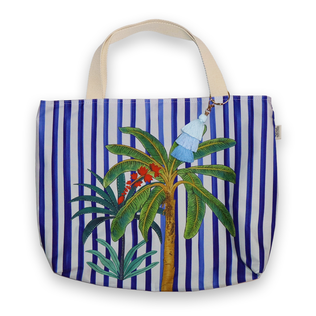 Tote bag with blue and white stripes and palm tree design on a white background