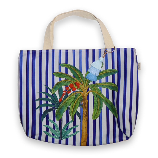Tote bag with blue and white stripes and palm tree design on a white background