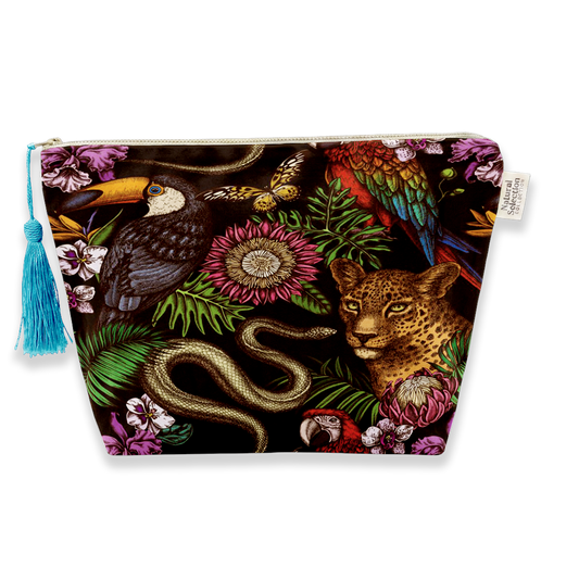 A rectangular zippered pouch featuring a vibrant, detailed jungle and wildlife print with a toucan, leopard, snake, and tropical flowers on a black background, complete with a blue tassel zipper pull.