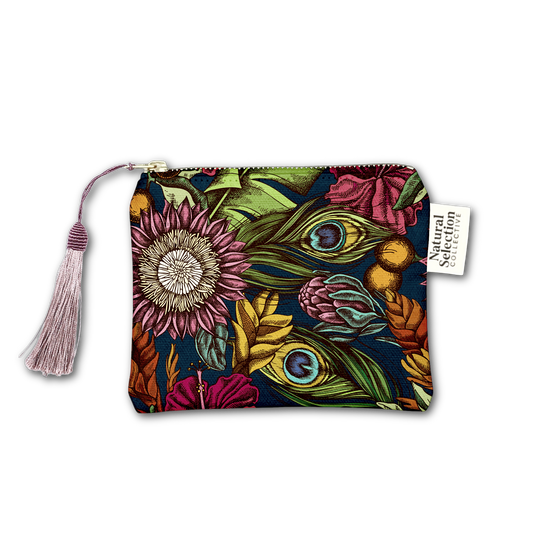 A zippered pouch featuring a vibrant, multicolor botanical and peacock feather pattern on a dark navy background, complete with a pink tassel zipper pull and a white brand tag reading 'Natural Selection'.