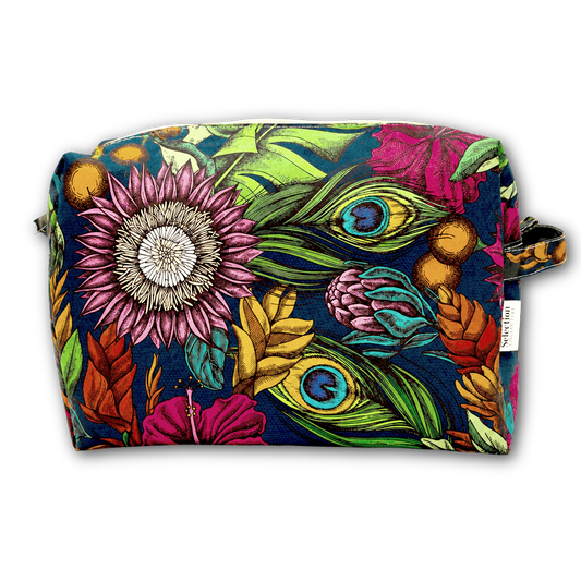 A rectangular zippered pouch featuring a vibrant, detailed botanical and peacock feather print on a dark navy background. The print includes pink flowers, green leaves, and golden-brown acorns.