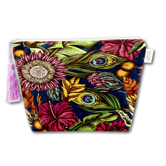 A zippered cosmetic pouch featuring a vibrant botanical and peacock feather print on a dark navy background, complete with a light purple tassel on the left and a white brand tag on the right.