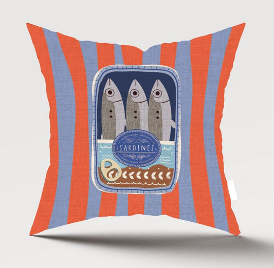 A square throw pillow with vertical orange and light blue stripes, featuring a central graphic of three sardines in a blue frame with the word 'SARDINES' and a small boat illustration.