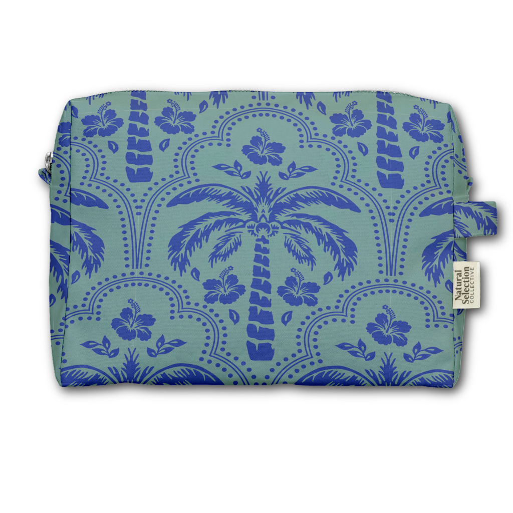 A rectangular zippered pouch with a tropical pattern featuring blue palm trees and hibiscus flowers on a light teal background, with a small fabric brand tag on the right side.
