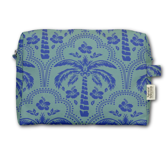 A rectangular zippered pouch with a tropical pattern featuring blue palm trees and hibiscus flowers on a light teal background, with a small fabric brand tag on the right side.