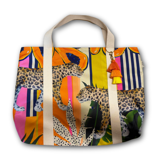 Colorful tote bag with leopard design and tassel on a white background