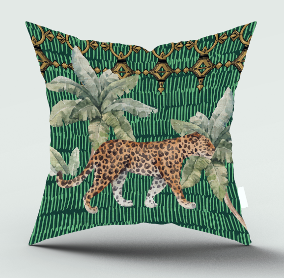 A square decorative throw pillow featuring a tropical jungle design with a walking leopard, palm leaves, and a green striped background with gold geometric accents, shown on a light gray studio background.