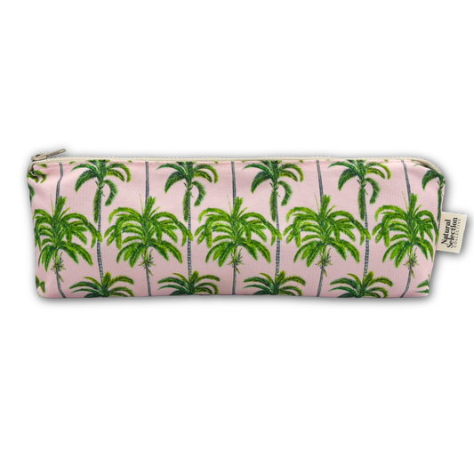 A rectangular zippered pouch with a pink background and a green palm tree pattern, shown on a plain white background. A small fabric brand tag is visible on the right side.