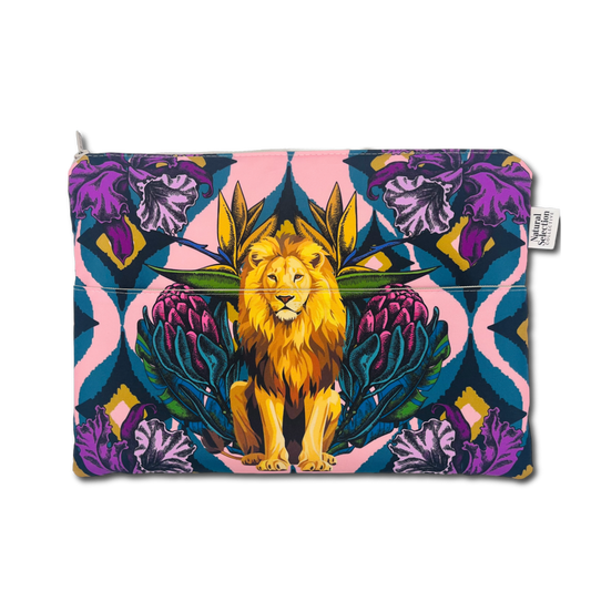 A zippered pouch featuring a vibrant, symmetrical graphic print of a golden lion seated among purple flowers and teal leaves on a pink and blue background, with a small white brand tag on the right side.