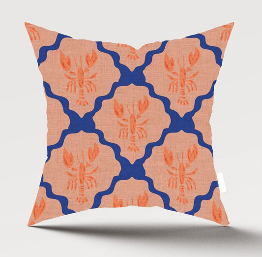 A square throw pillow featuring a repeating pattern of orange lobster motifs inside peach-colored scalloped ovals, separated by bold blue wavy lines, shown against a light gray background.