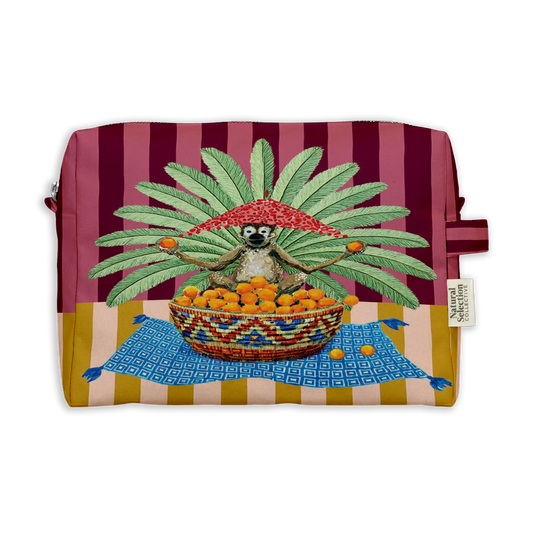 Manor Mischief Toiletry Bag featuring a lemur with a basket of oranges on pink and mustard stripes