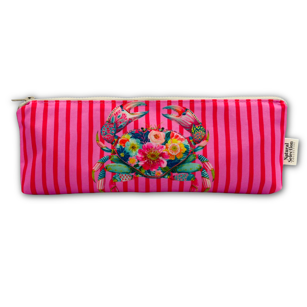 A rectangular zippered pouch with a vibrant pink and magenta vertical stripe pattern, featuring a colorful tropical crab and floral design on the front, with a small brand tag on the right side.