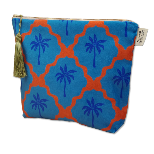 Blue pouch with palm tree pattern and tassel on a white background