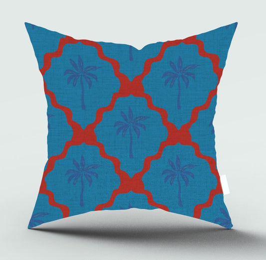 A square throw pillow featuring a blue and red Moroccan trellis pattern with dark blue palm tree silhouettes, shown against a light gray background.