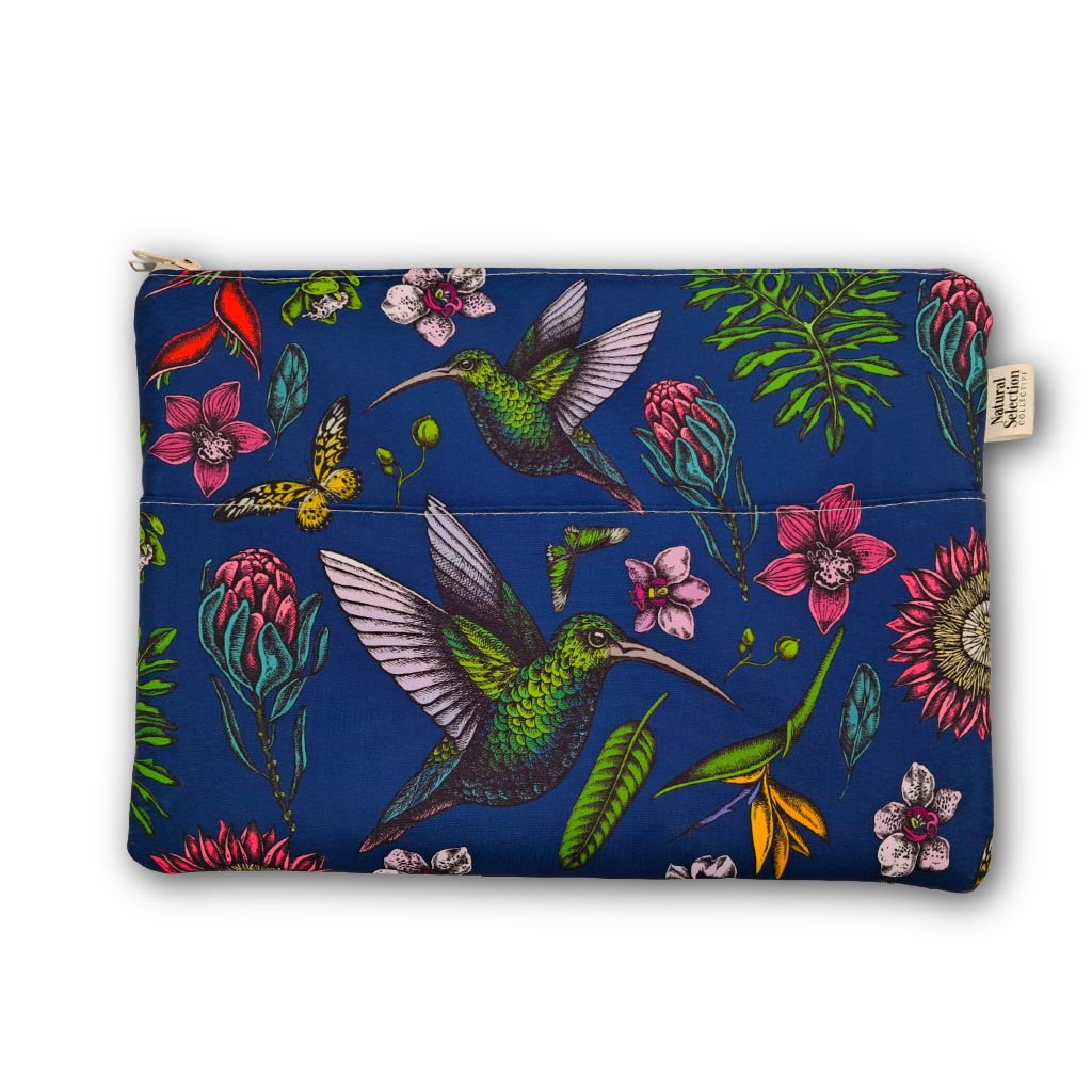A zippered pouch featuring a vibrant tropical print with green hummingbirds, pink flowers, and green leaves on a deep blue background, shown against a plain white studio backdrop.