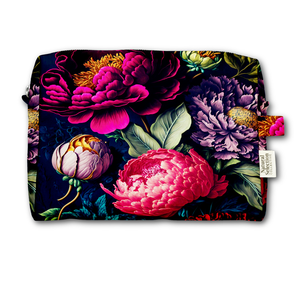 A rectangular cosmetic pouch featuring a vibrant, detailed botanical print of peonies and flowers in pink, purple, and green on a dark navy background. A small white fabric brand tag is visible on the right side.