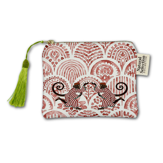 A small zip pouch with a white background and a dusty red hand-painted style pattern of two monkeys, featuring a bright green tassel on the left and a 'Soulful Collective' brand tag on the right.