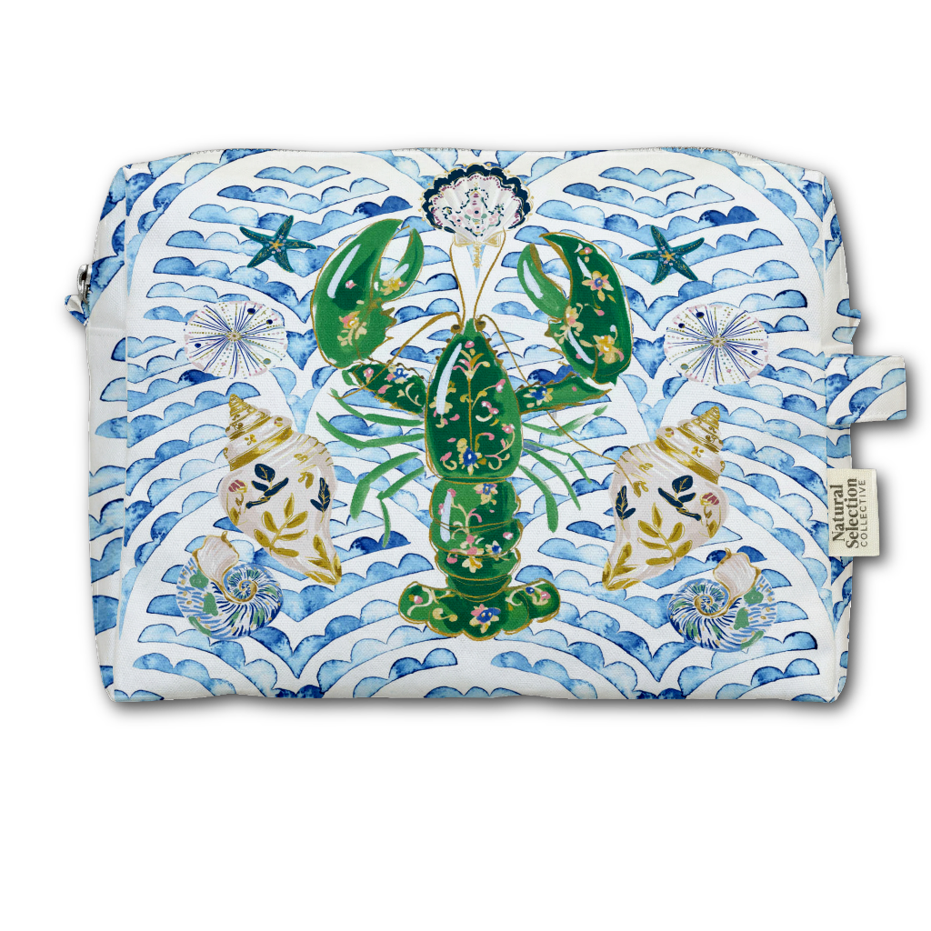 A rectangular zippered pouch featuring a colorful print of a green lobster, blue waves, and seashells on a white background, with a small side tag reading Natural Living.