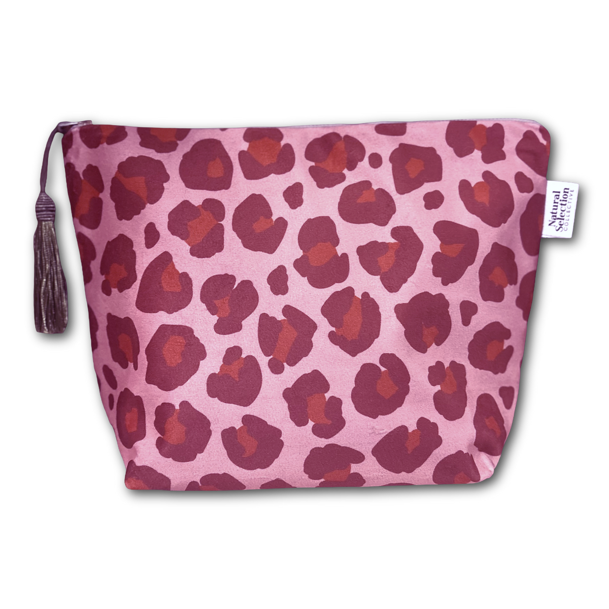A pink zippered pouch with a dark red and burgundy leopard print pattern, featuring a matching tassel zipper pull and a small white brand tag that reads 'Natural Living'.