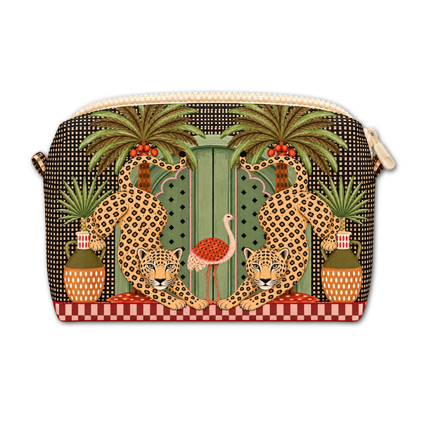 A zippered cosmetic pouch featuring a detailed tropical and jungle-themed print with two leopards, palm trees, a pink flamingo, and a red-and-white checkered base, shown on a plain white background.