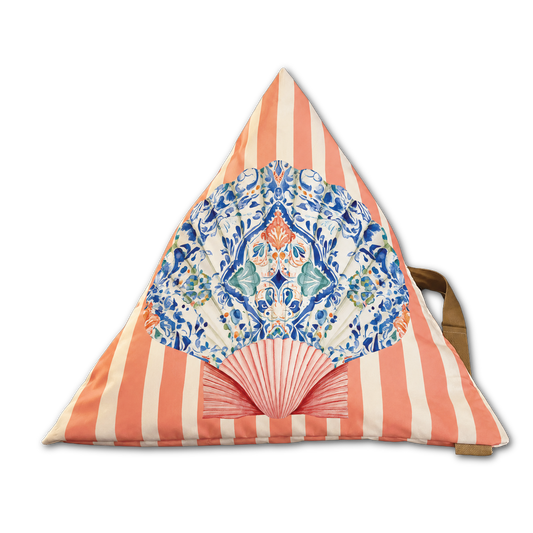 A triangular cushion or pillow with coral pink and off-white vertical stripes, featuring a large printed fan motif in blue, teal, and orange on the front, with a brown strap visible on the right side.