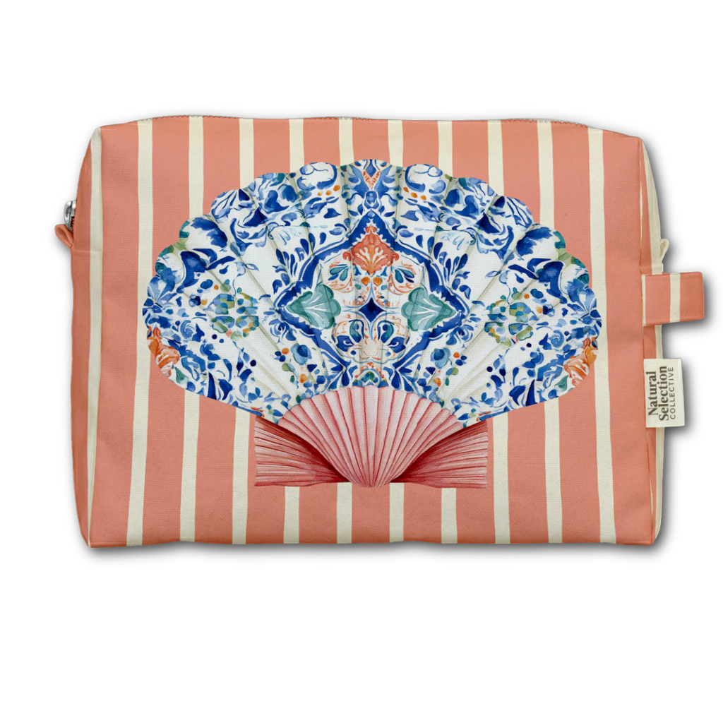 A rectangular cosmetic pouch with coral pink and cream vertical stripes, featuring a large printed folding fan design in blue, white, and orange on the front, with a small fabric brand tag reading Natural Living on the right side.