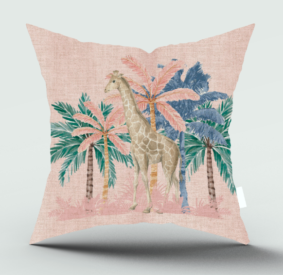 A square decorative throw pillow with a textured light pink linen-like background, featuring a central giraffe surrounded by pink and blue palm trees, shown against a light gray studio background.