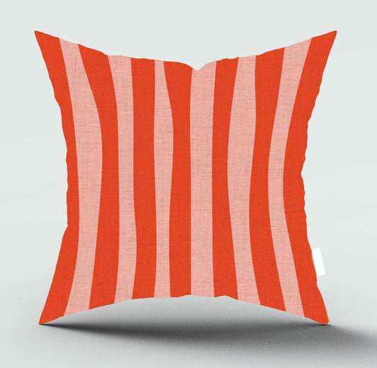 A square throw pillow with vertical wavy stripes in bright coral red and light pink, shown on a light gray background with a soft shadow underneath.
