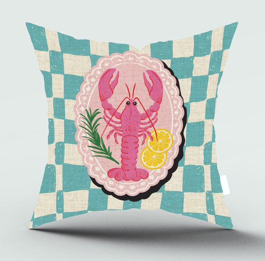 A square decorative throw pillow with a teal and cream checkered pattern, featuring a central graphic of a pink lobster on a pink oval background with lemon slices and green herbs.