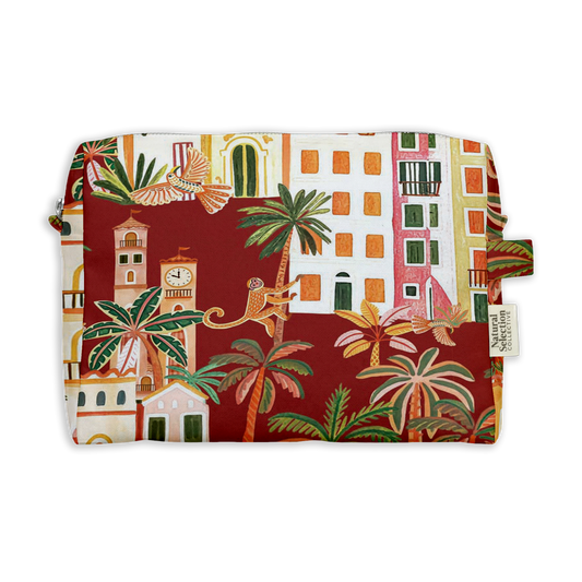 Sultan Monkey Toiletry Bag featuring a monkey among town buildings and palm trees on deep red