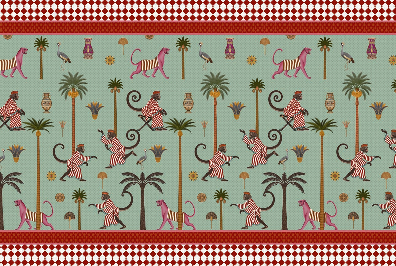 A repeating patterned fabric or wallpaper design featuring stylized apes in pink-and-white striped outfits, pink monkeys, palm trees, birds, and small decorative motifs on a mint green background, with red border bands at the top and bottom.