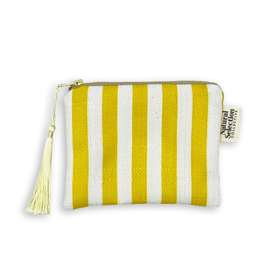A small fabric zip pouch with vertical yellow and white stripes, featuring a cream tassel zipper pull and a side tag reading Natural Selection.